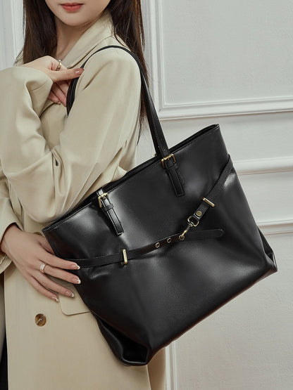 Sac Suthida noir porté à l’épaule avec un manteau beige