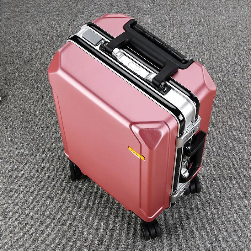 Valise Monaco rigide à cadre aluminium rose vue de trois quarts sur fond gris
